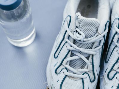 A pair of clean sports sneakers and a water bottle.
